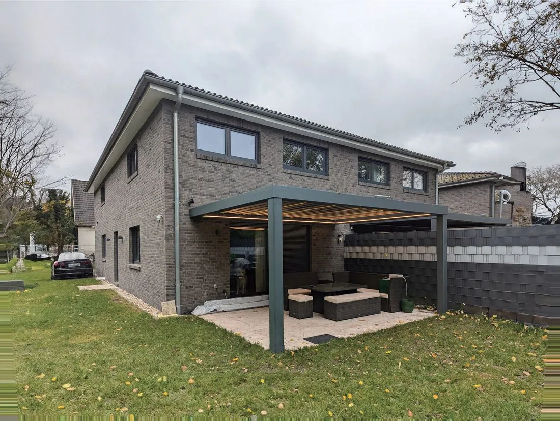 GM-220 motorised louvered pergola attached to a brick home